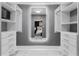 A spacious walk-in closet is well-lit with shelving and drawers across from an illuminated mirror at 116 Alcala Dr, Kissimmee, FL 34758