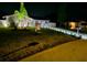 Night shot of home exterior featuring well-manicured lawn and professional landscape lighting at 116 Alcala Dr, Kissimmee, FL 34758