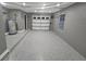 A gray garage has an epoxy floor and is well-lit, providing ample space for multiple purposes at 116 Alcala Dr, Kissimmee, FL 34758