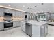 Bright kitchen with stainless steel appliances, gray cabinetry, tile backsplash, and a large center island at 116 Alcala Dr, Kissimmee, FL 34758
