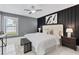 The main bedroom has a modern aesthetic with black wooden decor, white tile floors, and a comfortable, well-lit layout at 116 Alcala Dr, Kissimmee, FL 34758
