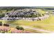 Aerial community view featuring well-maintained lawns, lush trees, and nearby roadways at 1204 Blackheath Ct, Davenport, FL 33897