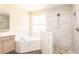 Modern bathroom featuring a large tub, and walk-in shower with decorative stone flooring at 1204 Blackheath Ct, Davenport, FL 33897