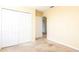 Bright bedroom featuring plush carpeting and a spacious closet with bi-fold doors at 1204 Blackheath Ct, Davenport, FL 33897