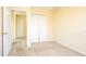 Bedroom with neutral carpet, closet, and an entrance to another room at 1204 Blackheath Ct, Davenport, FL 33897