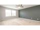 Expansive bedroom with a ceiling fan, plush carpeting, and generous natural light from a large window at 1204 Blackheath Ct, Davenport, FL 33897