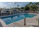 Relaxing community pool area with lounge chairs, umbrellas, and well-maintained landscaping at 1204 Blackheath Ct, Davenport, FL 33897