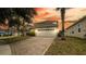 Two-story home with a brick-paved driveway and a well-maintained front yard at 1204 Blackheath Ct, Davenport, FL 33897