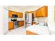 Well-lit kitchen with stainless steel appliances, ample wood cabinetry, and tile flooring at 1204 Blackheath Ct, Davenport, FL 33897
