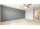 Large main bedroom with plush carpet, a ceiling fan, and an en-suite bathroom at 1204 Blackheath Ct, Davenport, FL 33897