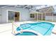 Private screened-in pool featuring a swimming pool and a hot tub at 1204 Blackheath Ct, Davenport, FL 33897