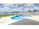 Relaxing screened-in pool area complete with a swimming pool and hot tub at 1204 Blackheath Ct, Davenport, FL 33897