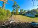Large backyard featuring lush green grass, mature trees, and the back of the house at 1221 Oak Haven Dr, Altamonte Springs, FL 32714