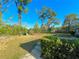 Backyard with green grass, mature trees, steps and rear view of the house at 1221 Oak Haven Dr, Altamonte Springs, FL 32714