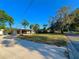 Street view of a house surrounded by a well-maintained lawn and mature trees under a clear blue sky at 1221 Oak Haven Dr, Altamonte Springs, FL 32714
