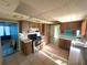 Kitchen with stainless steel appliances and cabinetry, and tile floor, open to connecting rooms at 1221 Oak Haven Dr, Altamonte Springs, FL 32714