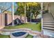 Lush backyard with artificial turf, featuring a fire pit, lounge chairs and a hot tub at 13 Hill Ave, Orlando, FL 32801
