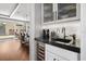 Stylish bar area with wine cooler, sink, and modern cabinetry at 13 Hill Ave, Orlando, FL 32801