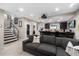 Finished basement with a cozy seating area and a stylish bar with counter seating and storage at 13 Hill Ave, Orlando, FL 32801