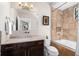 Elegant bathroom featuring a soaking tub with tiled surround and a modern vanity with stylish fixtures at 13 Hill Ave, Orlando, FL 32801