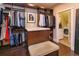 Custom walk-in closet with generous storage and bench, conveniently adjacent to the laundry room at 13 Hill Ave, Orlando, FL 32801