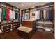 Custom walk-in closet featuring shelving, hanging racks, drawers, and a central bench at 13 Hill Ave, Orlando, FL 32801