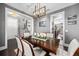 Formal dining room with decorative chandelier, hardwood floors, and views of the staircase at 13 Hill Ave, Orlando, FL 32801