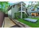 Landscaped backyard with a hot tub and two-story accessory building at 13 Hill Ave, Orlando, FL 32801