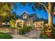 Landscaped home with a brick paved driveway and a covered carport at 13 Hill Ave, Orlando, FL 32801