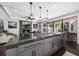 Modern kitchen island with granite countertops, gas range, and pendant lighting open to the living room at 13 Hill Ave, Orlando, FL 32801