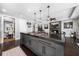 Modern kitchen with a large island, gas range, granite countertops, and stainless steel appliances at 13 Hill Ave, Orlando, FL 32801