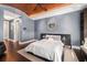 Stylish bedroom with a wood-planked ceiling, gray walls, and a decorative mirror above the headboard at 13 Hill Ave, Orlando, FL 32801