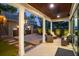 A covered patio offers outdoor seating, a view of the garage, and palm trees at 13 Hill Ave, Orlando, FL 32801