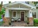 Inviting front porch with comfortable seating and a brick-paved surface at 13 Hill Ave, Orlando, FL 32801