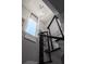 Modern staircase with metal railing, unique lighting, and decorative wall art at 13 Hill Ave, Orlando, FL 32801