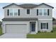 Charming two-story home featuring a neutral color scheme, a two-car garage, and well-maintained landscaping at 1391 Dalkeith Cv, Sanford, FL 32771