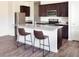 Modern kitchen with stainless steel appliances, granite countertops, dark wood cabinets, and breakfast bar seating at 1391 Dalkeith Cv, Sanford, FL 32771