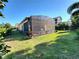 Private backyard with lush green grass, mature landscaping, and a screened-in patio area at 15707 Cutter Sail Pl, Winter Garden, FL 34787