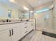 Luxurious bathroom featuring a double vanity and large walk-in shower at 15707 Cutter Sail Pl, Winter Garden, FL 34787