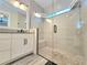 Modern bathroom with sleek glass shower and neutral tiling at 15707 Cutter Sail Pl, Winter Garden, FL 34787