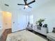 Bright bedroom featuring neutral colors, a ceiling fan, and double-door closet at 15707 Cutter Sail Pl, Winter Garden, FL 34787