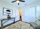 Bedroom featuring double door closet, ceiling fan, and neutral decor at 15707 Cutter Sail Pl, Winter Garden, FL 34787