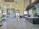 Spacious clubhouse featuring high ceilings, ample seating, a kitchenette, and neutral decor at 15707 Cutter Sail Pl, Winter Garden, FL 34787