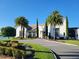 Community clubhouse surrounded by lush landscaping and palm trees at 15707 Cutter Sail Pl, Winter Garden, FL 34787