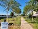 Landscaped community path leads to a lake at 15707 Cutter Sail Pl, Winter Garden, FL 34787