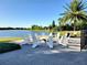 Cozy outdoor seating area featuring a firepit with Adirondack chairs and a relaxing lake view at 15707 Cutter Sail Pl, Winter Garden, FL 34787