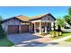 Charming curb appeal with stone accents and well-manicured landscaping at 15707 Cutter Sail Pl, Winter Garden, FL 34787