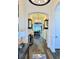 Long hallway with wood floors, stylish lighting, and access to living spaces at 15707 Cutter Sail Pl, Winter Garden, FL 34787