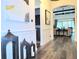 Hallway features hardwood floors, decorative wall paneling, and views of living areas at 15707 Cutter Sail Pl, Winter Garden, FL 34787