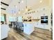 Bright, open kitchen featuring a large island, modern appliances, and stylish pendant lighting at 15707 Cutter Sail Pl, Winter Garden, FL 34787